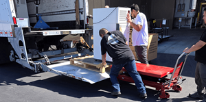 Workers load lab equipment into truck
