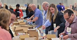 Employees packing boxes at a food drive.