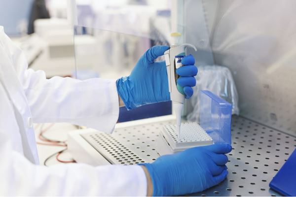Image of a researcher pipetting 