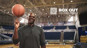 Basketball star Jamal Mashburn spinning a ball on his finger.