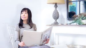 Woman sits with book