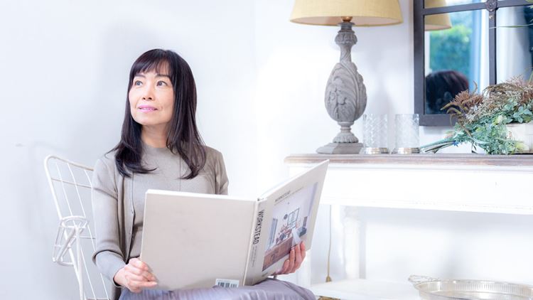 Woman sits with book