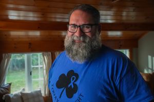 Tim smiles in a blue colorectal cancer awareness t-shirt