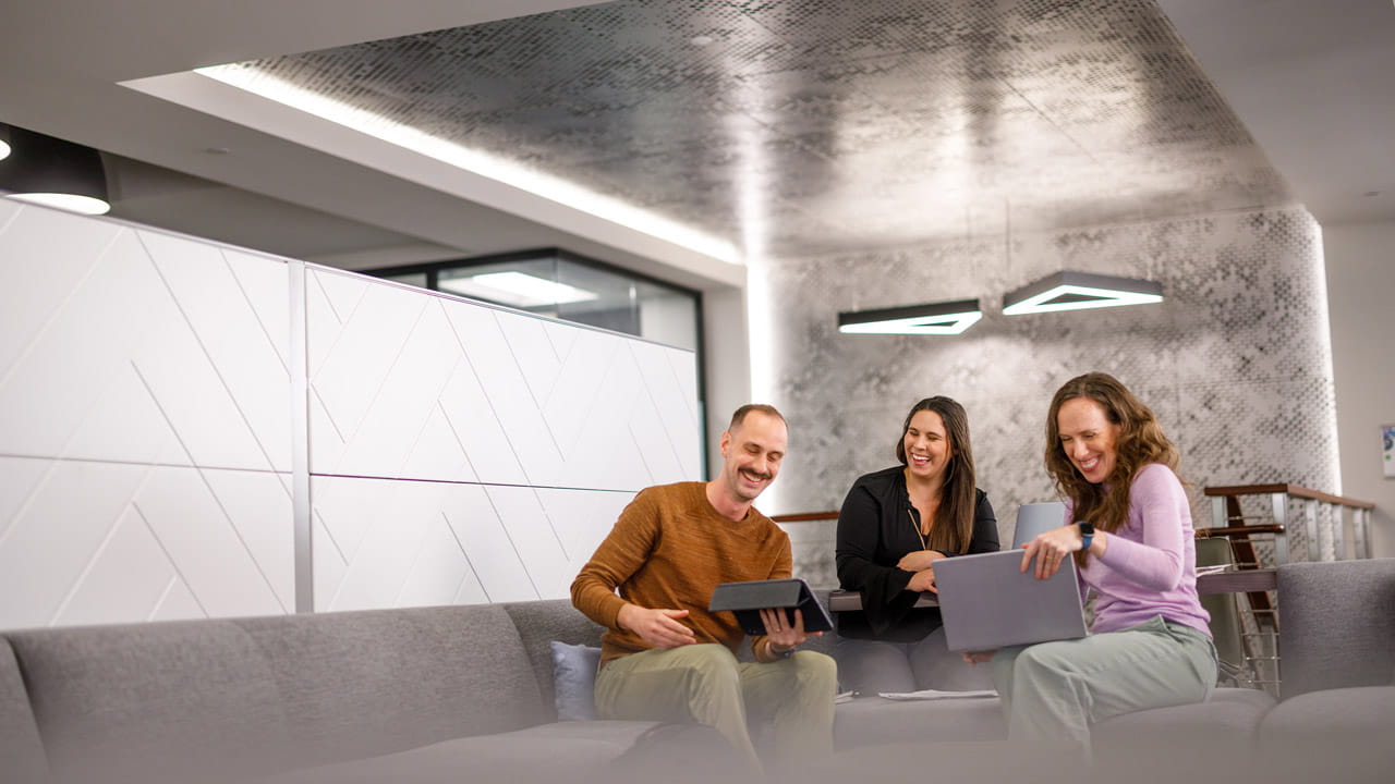 Three employees collaborating in the Exact Sciences San Diego office