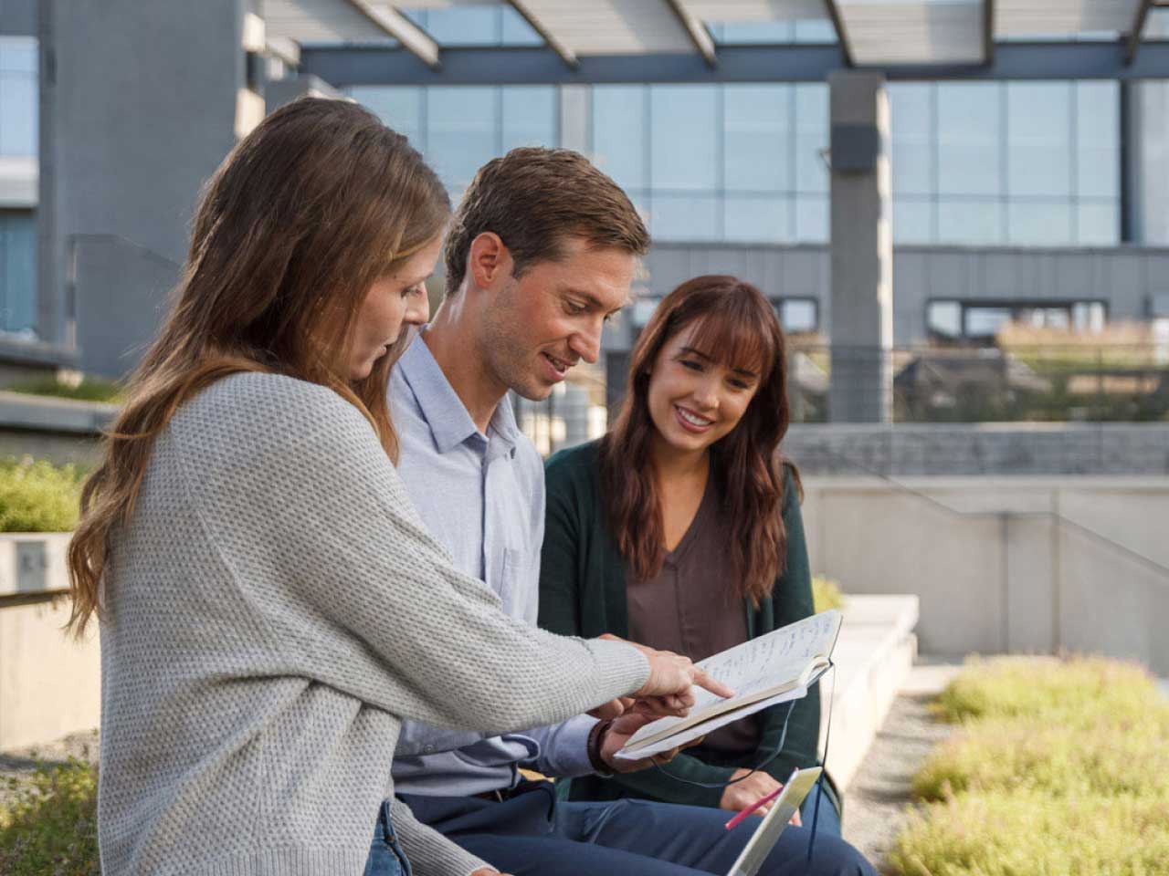 Three Exact Sciences' associates collaborating in the Wisconsin headquarters' atrium.