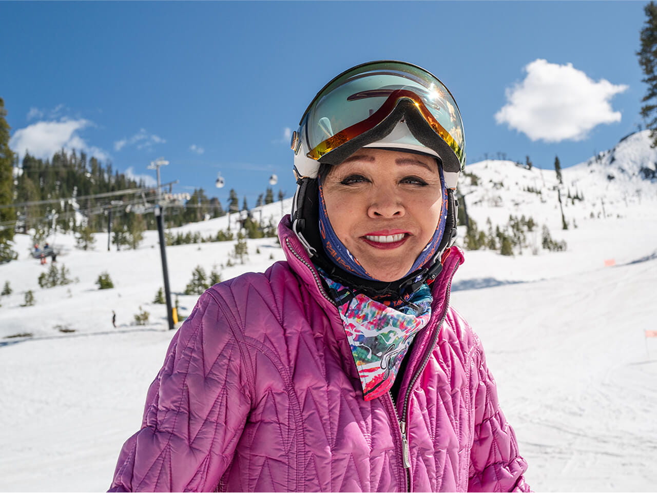 Katherine in ski gear smiling on a snowy slope.