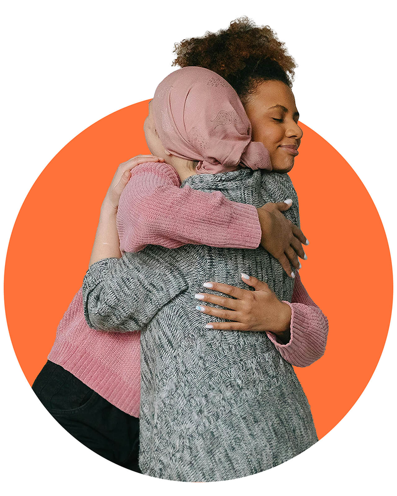 Two women hugging and smiling.