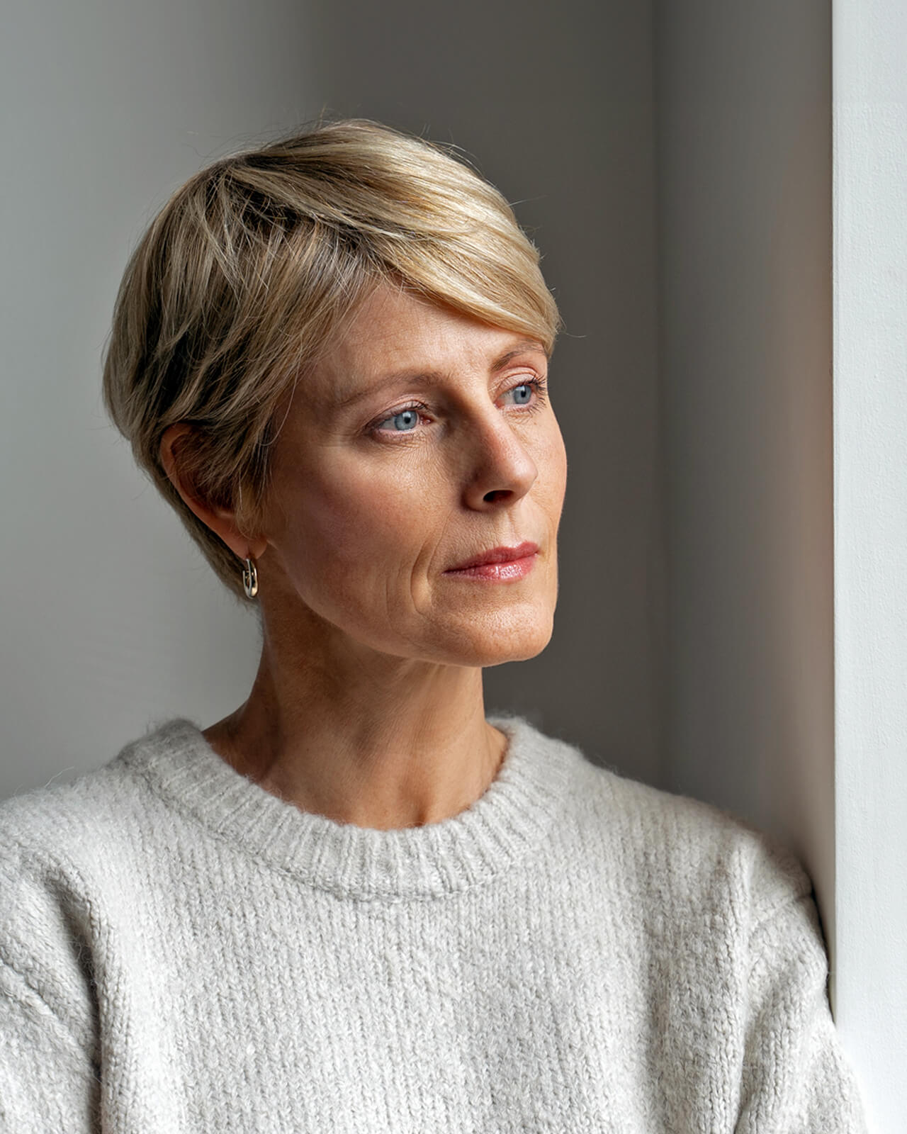 A blonde woman looking off to the distance.