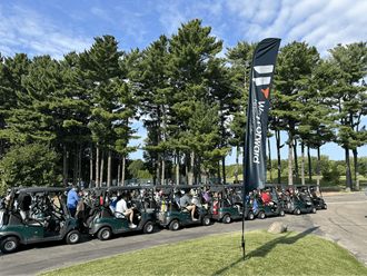 Golfers lining up in golf carts to head out to the course during the Chip In to End Hunger event.