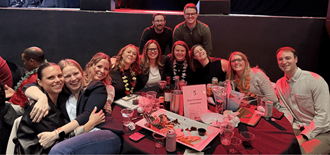 Exact Sciences colleagues smiling together at a trivia night event.